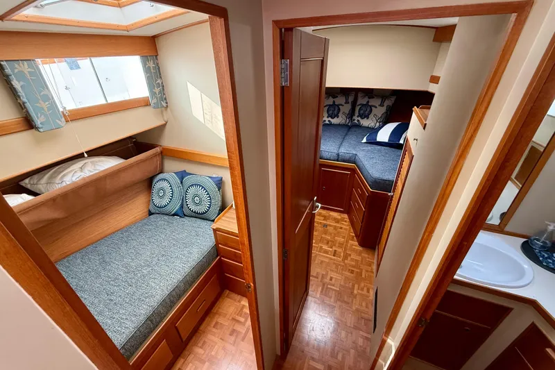 Slide: The Image of 1982 Grand Banks 42 Motoryacht interior with cozy twin cabins and wooden finishes. - 16