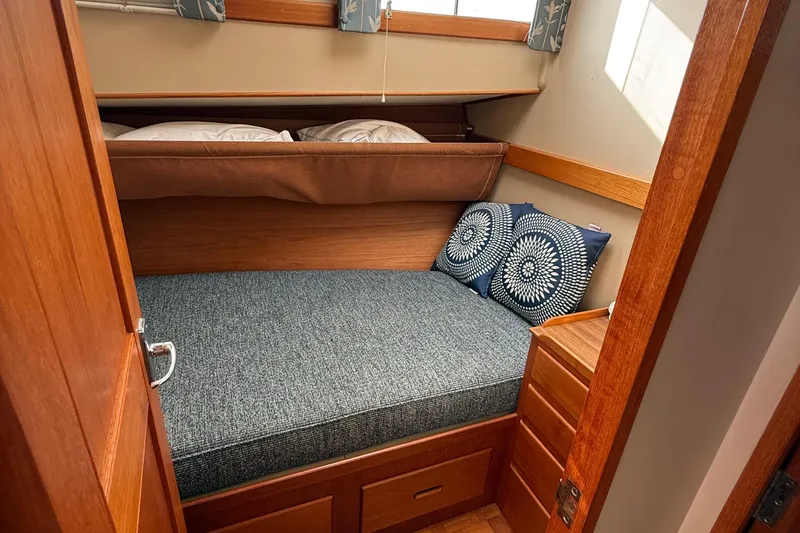 Slide: The Image of Cozy cabin interior of 1982 Grand Banks 42 Motoryacht with bed and decorative pillows. - 18