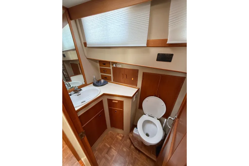 Slide: The Image of Bathroom interior of 1982 Grand Banks 42 Motoryacht with wood cabinetry and white fixtures. - 19