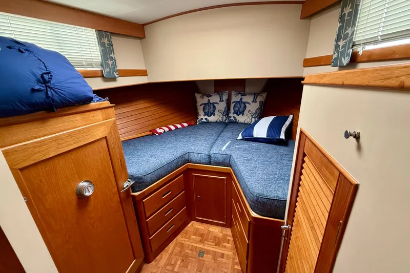 Slide: The Image of Cozy cabin interior of 1982 Grand Banks 42 Motoryacht with blue bedding and wooden cabinetry. - 21