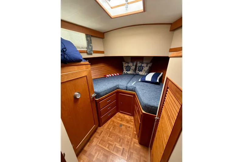 Slide: The Image of Cozy cabin interior of 1982 Grand Banks 42 Motoryacht with wooden furnishings and nautical decor. - 22