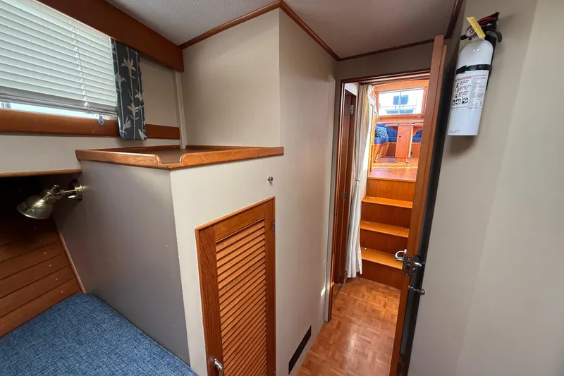 Slide: The Image of 1982 Grand Banks 42 Motoryacht interior with wooden finishes and staircase. - 24