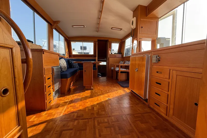 Slide: The Image of Interior of 1982 Grand Banks 42 Motoryacht with wooden furnishings and seating area. - 25