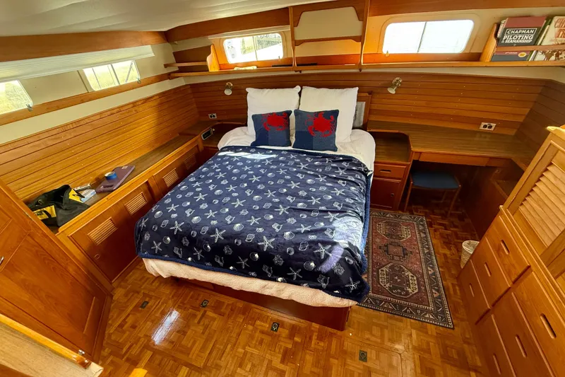 Slide: The Image of Luxurious 1982 Grand Banks 42 Motoryacht cabin with cozy bed and wooden interior. - 26