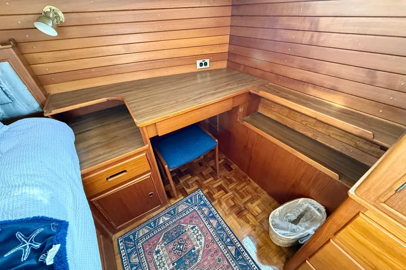 Slide: The Image of 1982 Grand Banks 42 Motoryacht interior with wooden desk, chair, and nautical decor. - 29