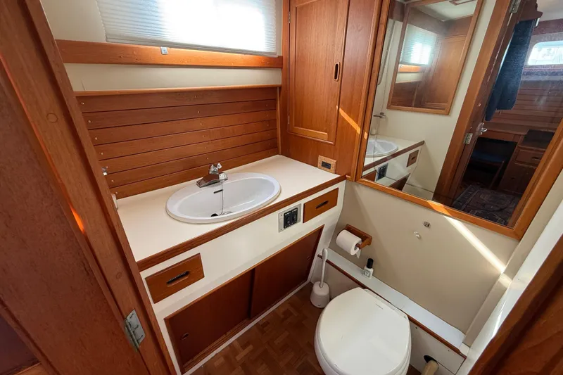 Slide: The Image of 1982 Grand Banks 42 Motoryacht bathroom with wooden cabinetry and modern fixtures. - 32