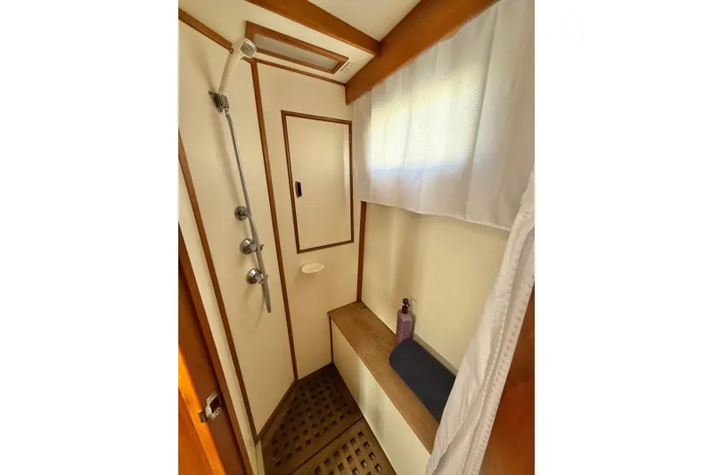 Slide: The Image of Shower area in 1982 Grand Banks 42 Motoryacht with wooden accents and curtain. - 34