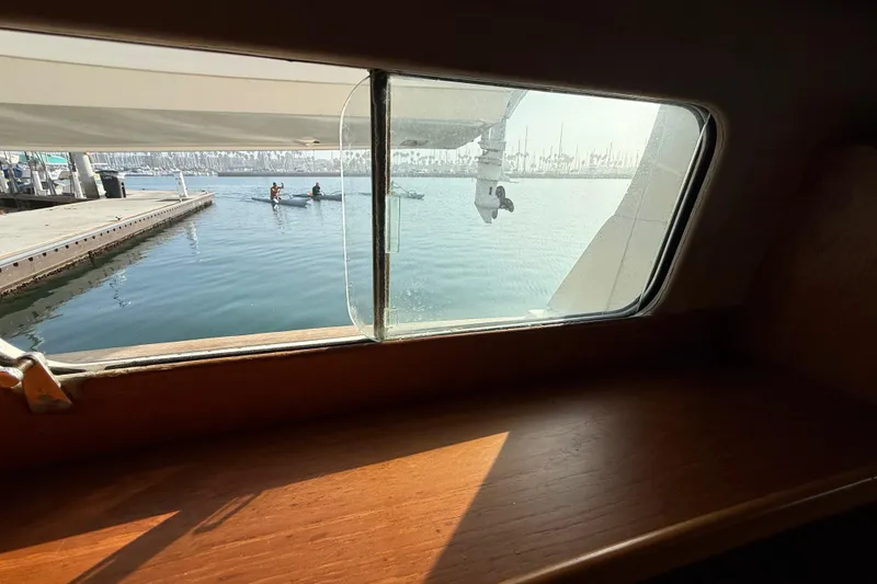 Slide: The Image of View from 1982 Grand Banks 42 Motoryacht window overlooking marina and kayakers. - 36