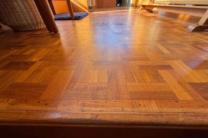 Slide: The Image of Wooden parquet flooring inside a 1982 Grand Banks 42 Motoryacht, showcasing warm tones and intricate patterns. - 38