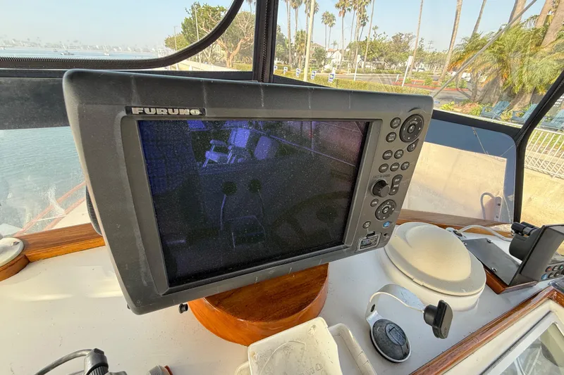 Slide: The Image of Furuno navigation system on 1982 Grand Banks 42 Motoryacht, docked with palm trees visible. - 41