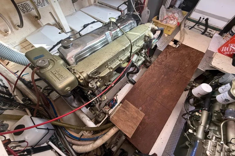Slide: The Image of Engine room of 1982 Grand Banks 42 Motoryacht with visible engine components and wiring. - 46