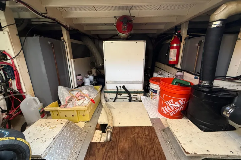 Slide: The Image of Engine room of 1982 Grand Banks 42 Motoryacht with equipment and storage items. - 55