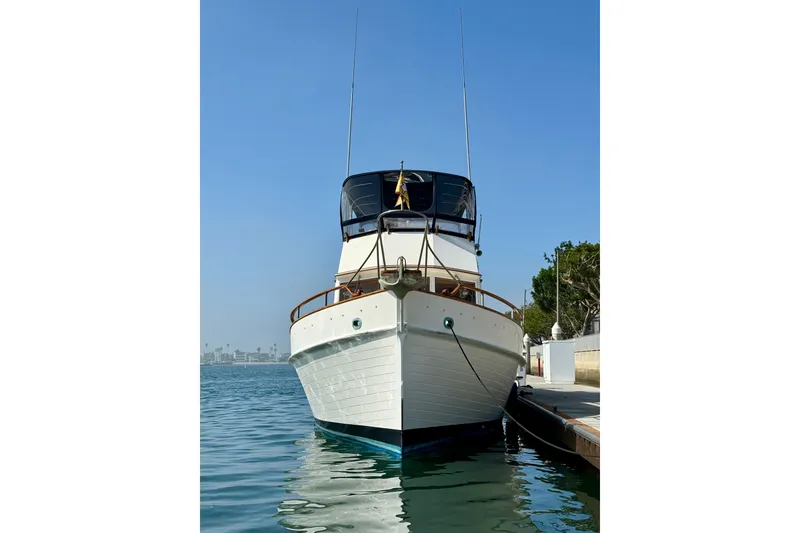 Slide: The Image of 1982 Grand Banks 42 Motoryacht docked in calm waters under clear blue sky. - 6