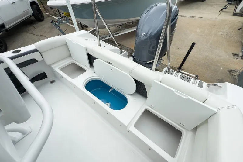 Slide: The Image of 2026 Tidewater 220 LXF boat, spacious deck, sleek design, white and black accents. - 11