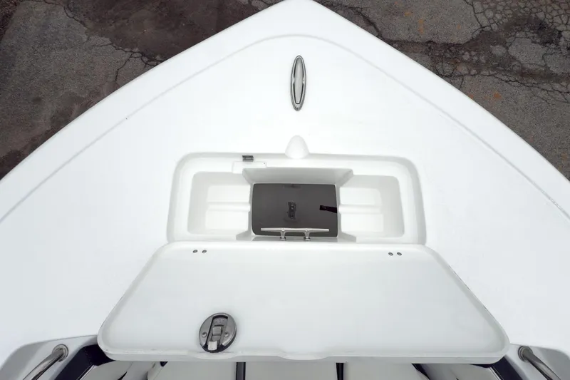 Slide: The Image of 2026 Tidewater 220 LXF boat interior with open storage compartments and cushioned seating. - 13