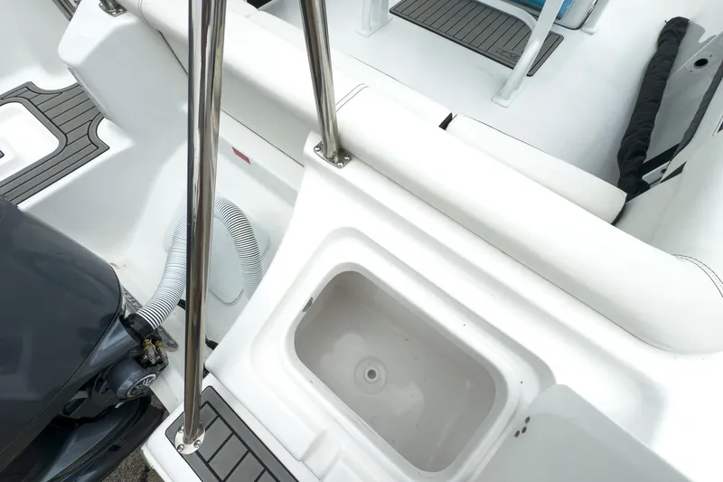 Slide: The Image of 2026 Tidewater 220 LXF boat interior with seating and engine view. - 17