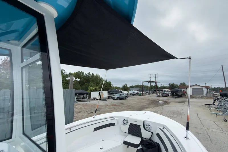 Slide: The Image of 2026 Tidewater 220 LXF boat with blue hull and black canopy on trailer. - 20