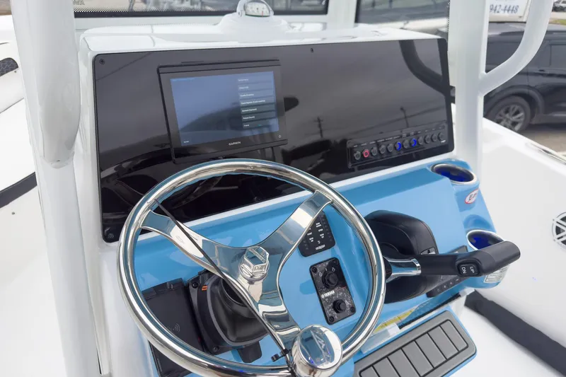 Slide: The Image of 2026 Tidewater 220 LXF boat interior with dual seats and steering wheel. - 7
