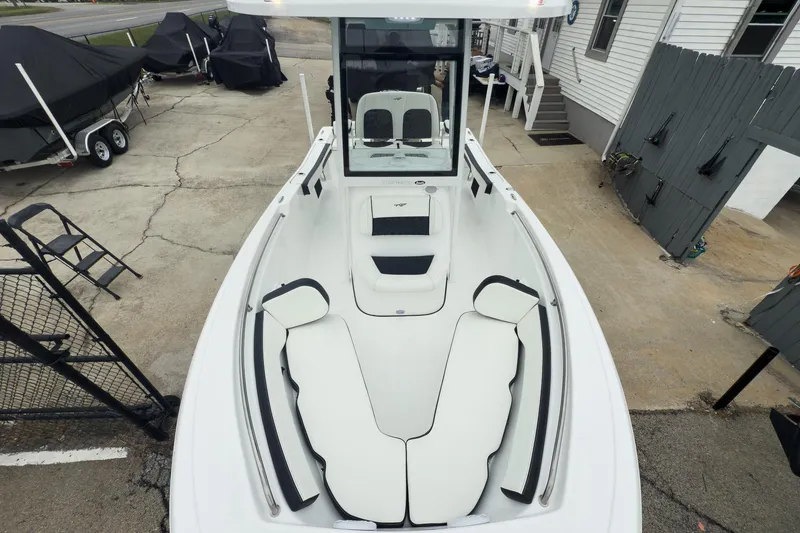 Slide: The Image of 2026 Tidewater 198 CC Adventure boat with white seating, docked outdoors. - 12