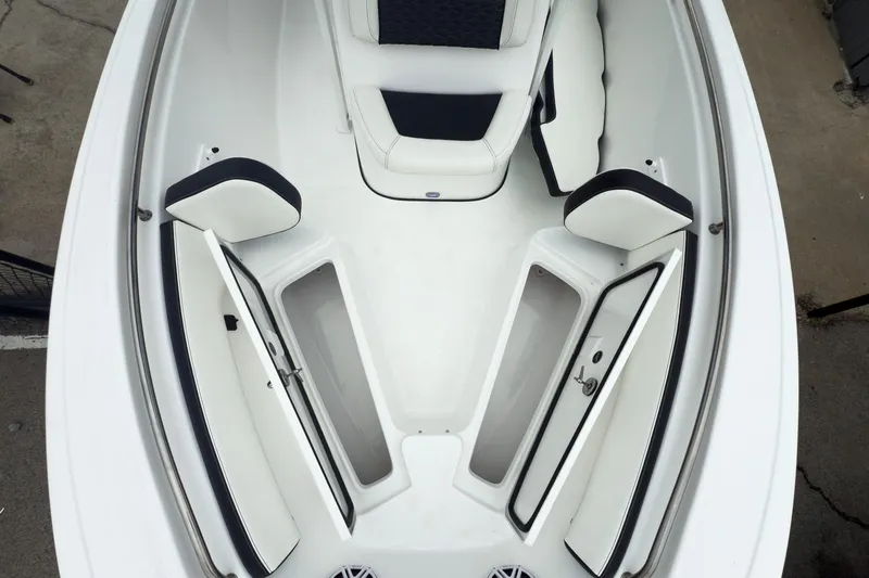 Slide: The Image of 2026 Tidewater 198 CC Adventure boat interior with open storage compartments and cushioned seating. - 13