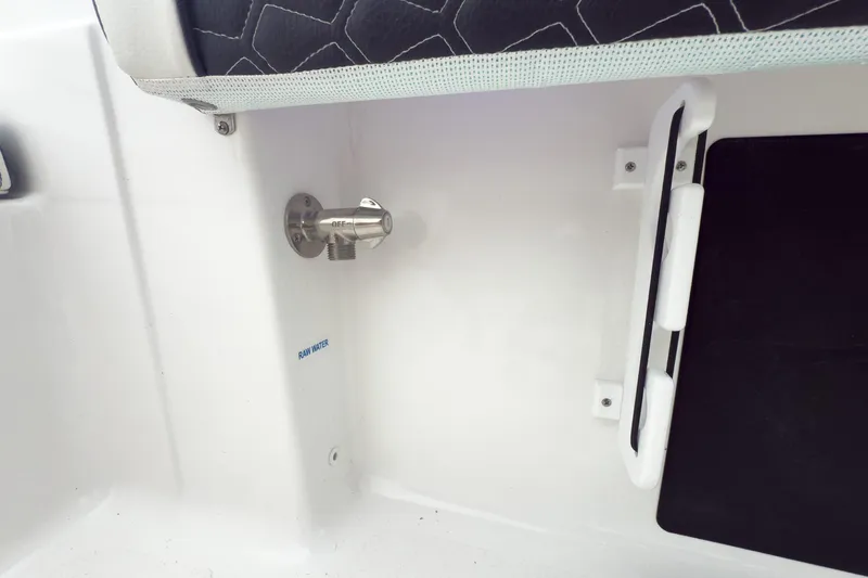 Slide: The Image of 2026 Tidewater 198 CC Adventure boat interior with raw water valve and seating detail. - 18