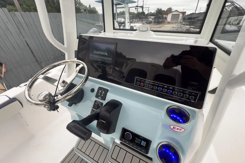 Slide: The Image of 2026 Tidewater 198 CC Adventure boat dashboard with Garmin display and steering wheel. - 20