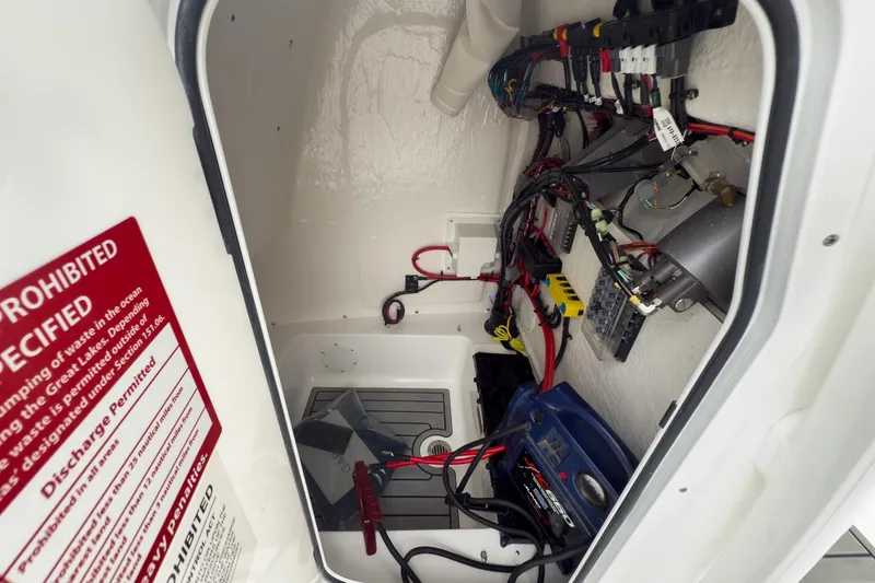 Slide: The Image of Electrical wiring and components inside a 2026 Tidewater 198 CC Adventure boat compartment. - 21
