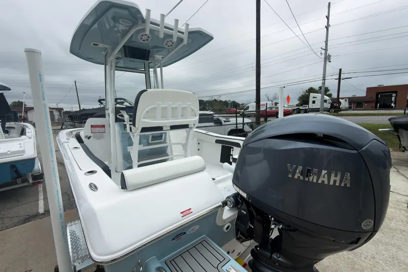Slide: The Image of 2026 Tidewater 198 CC Adventure boat with Yamaha engine, parked outdoors. - 22