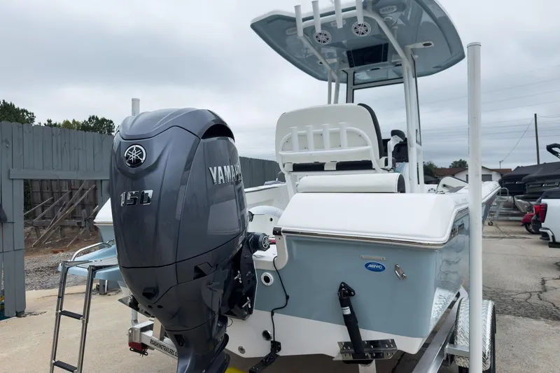 Slide: The Image of 2026 Tidewater 198 CC Adventure boat with Yamaha 150 engine, docked outdoors. - 23