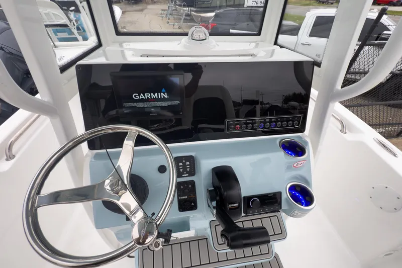 Slide: The Image of 2026 Tidewater 198 CC Adventure boat console with Garmin display and steering wheel. - 6