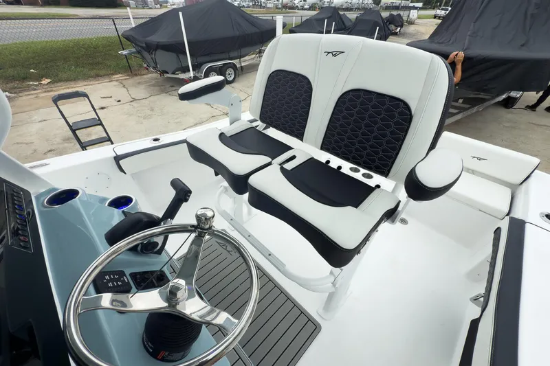 Slide: The Image of 2026 Tidewater 198 CC Adventure boat interior with steering wheel and cushioned seating. - 7