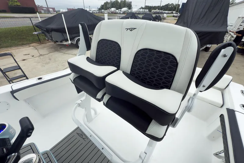 Slide: The Image of 2026 Tidewater 198 CC Adventure boat seats with black and white upholstery, outdoor setting. - 8