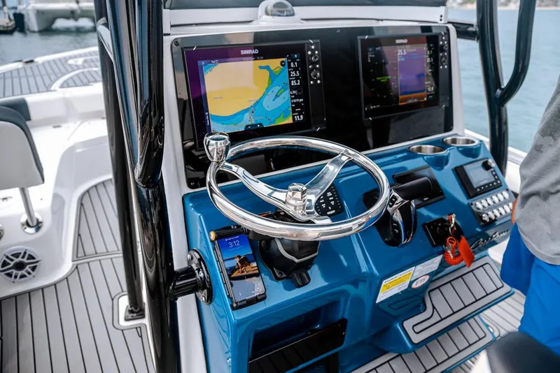 Slide: The Image of 2026 Tidewater 2500 Carolina Bay boat stern with storage compartments and motor. - 10