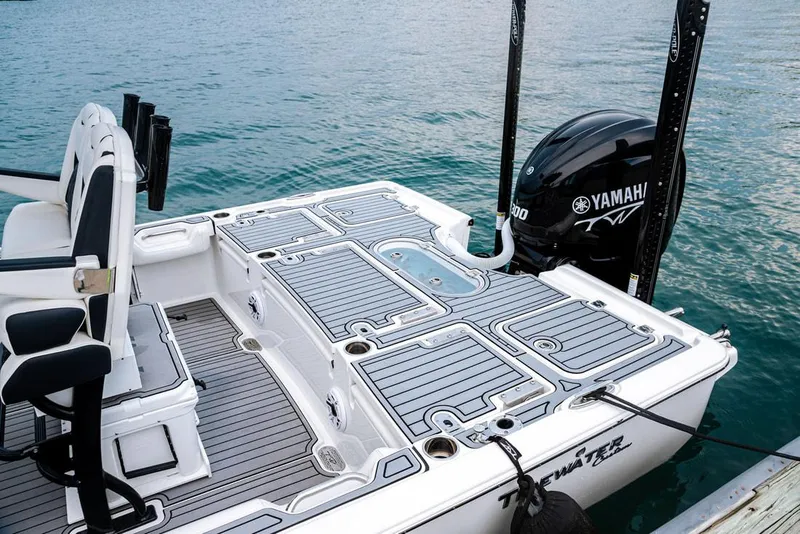 Slide: The Image of 2026 Tidewater 2500 Carolina Bay boat interior with steering wheel and rod holders. - 11