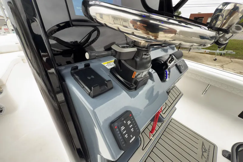 Slide: The Image of 2026 Tidewater 2500 Carolina Bay boat console with advanced controls and steering wheel. - 16