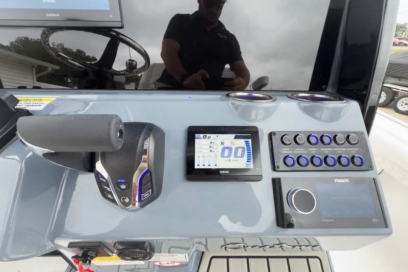 Slide: The Image of Control panel of 2026 Tidewater 2500 Carolina Bay boat with advanced navigation and audio systems. - 17