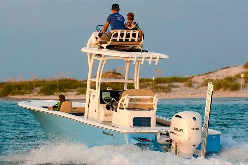 Slide: The Image of 2026 Tidewater 2500 Carolina Bay boat with Yamaha engine, parked on a trailer. - 2