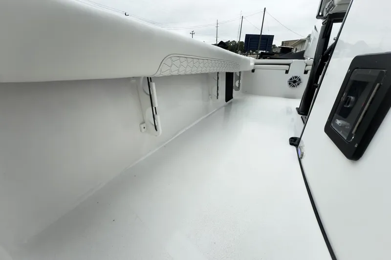 Slide: The Image of 2026 Tidewater 2500 Carolina Bay boat interior, showcasing sleek white deck and modern design. - 21