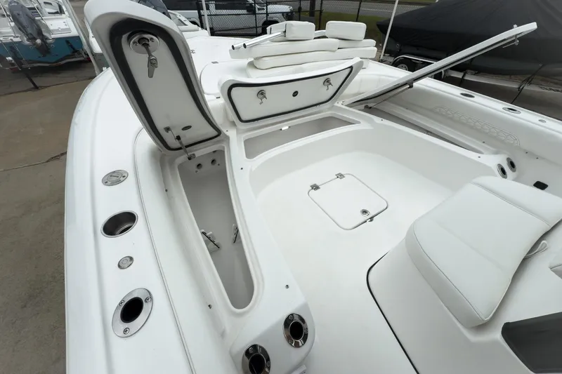 Slide: The Image of 2026 Tidewater 2500 Carolina Bay boat interior with open storage compartments and seating. - 25