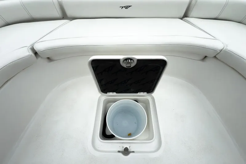 Slide: The Image of 2026 Tidewater 2500 Carolina Bay boat interior with storage compartment and bucket. - 26