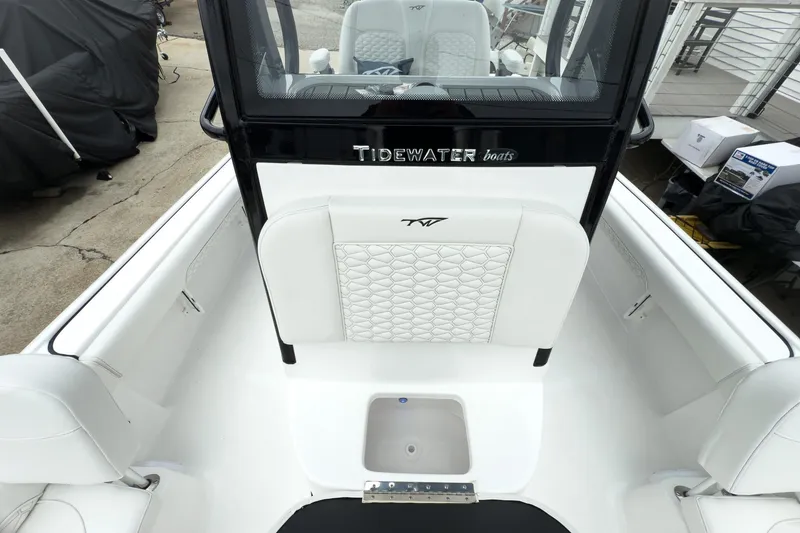Slide: The Image of 2026 Tidewater 2500 Carolina Bay boat interior with white seating and console. - 29