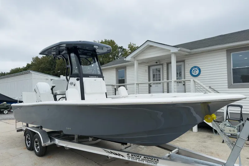 Slide: The Image of 2026 Tidewater 2500 Carolina Bay boat on trailer, parked outside a building. - 31