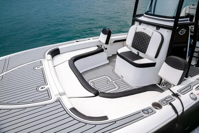 Slide: The Image of 2026 Tidewater 2500 Carolina Bay boat with white cushioned seating and speakers. - 8