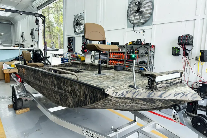 The Image of 2026 Excel 1751 Viper F4 boat in workshop, featuring camouflage design and modern equipment. - 0