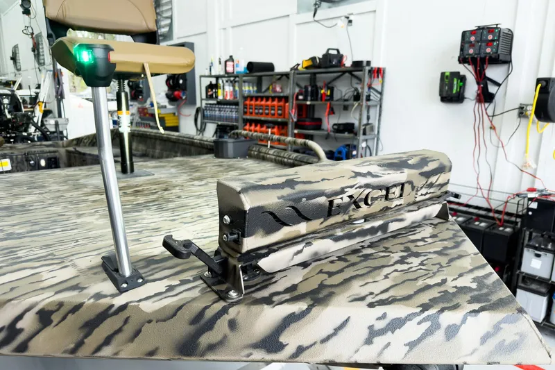 Slide: The Image of 2026 Excel 1751 Viper F4 boat in workshop, featuring camouflage design and modern equipment. - 11