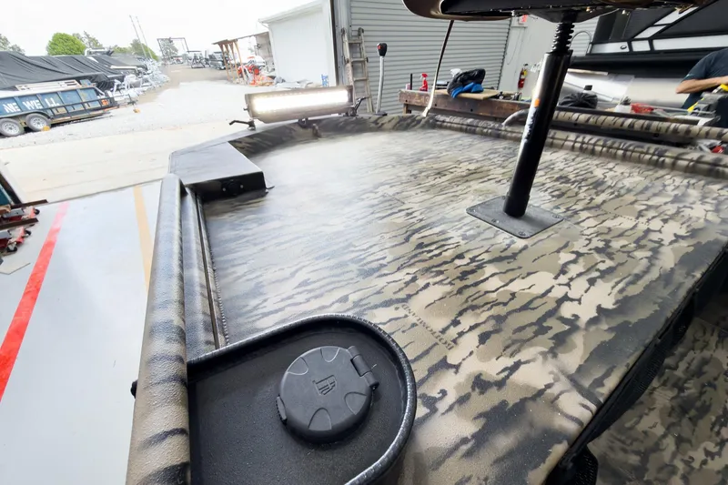 Slide: The Image of 2026 Excel 1751 Viper F4 boat with camouflage pattern in a workshop setting. - 17