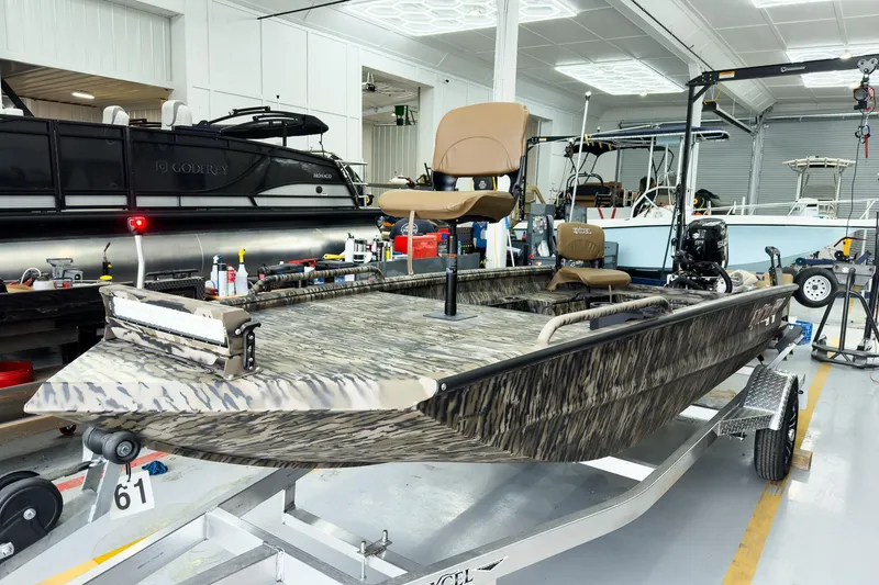 Slide: The Image of 2026 Excel 1751 Viper F4 boat in showroom, featuring camouflage design and elevated seating. - 2