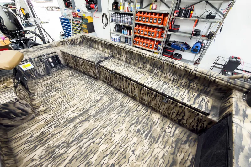 Slide: The Image of 2026 Excel 1751 Viper F4 boat interior with camouflage design in a workshop setting. - 20