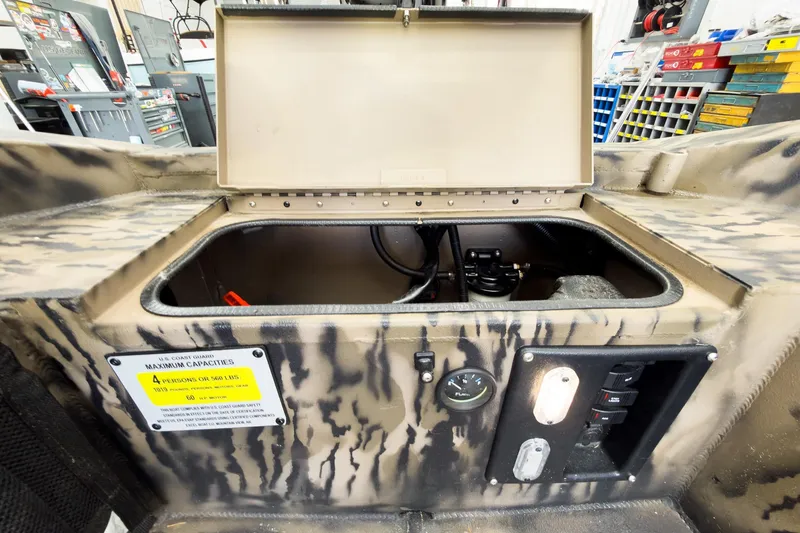 Slide: The Image of Open storage compartment in Excel 1751 Viper F4 boat, showcasing interior and control panel. - 23