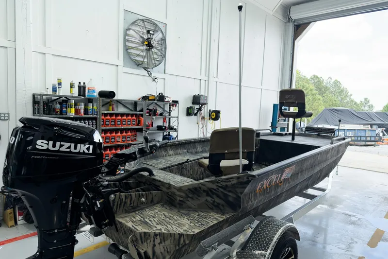 Slide: The Image of 2026 Excel 1751 Viper F4 boat with Suzuki engine in a garage setting. - 6